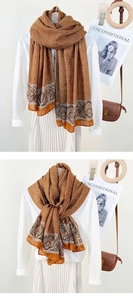 Detail of vintage orange scarf with chain and paisley prints on white shirt