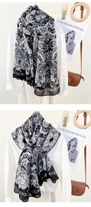 Detail view of black and white paisley floral scarf draped over a white shirt