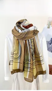 Detail of vintage geometric print scarf draped on a white shirt with a stylish look