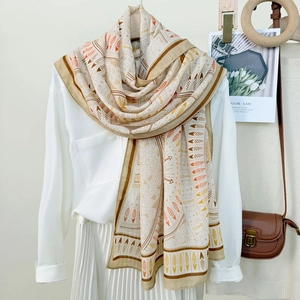 Women's bohemian scarf with geometric tribal prints in warm orange and beige tones