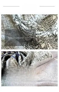 Macro shot of paisley silk scarf with detailed navy and grey pattern and soft texture