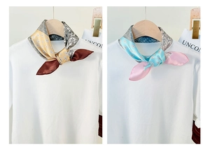 Detail of silk scarves with paisley patterns in yellow-brown and light blue colorways