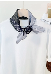 Detail of silk scarf with paisley patterns in black white and gray silk satin texture