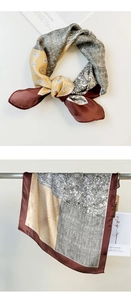 Detail of silk scarf with paisley print showing drape effect and smooth satin texture