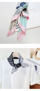 Detailed view of printed silk scarves featuring classic paisley patterns and satin texture