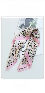 Detail of silk scarf with floral print, pink stitching, and soft skin-friendly texture
