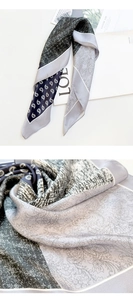 Detailed macro of silk scarf fabric showing paisley patterns and herringbone texture