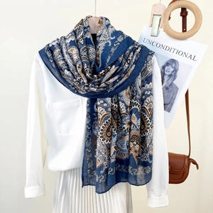 Bohemian paisley print long scarf in navy blue, draped over a white summer outfit