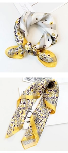 Detail of silk scarves with floral prints and yellow stripes in elegant bow styles