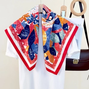 Colorful silk-like square scarf with abstract floral prints and red borders on white tee