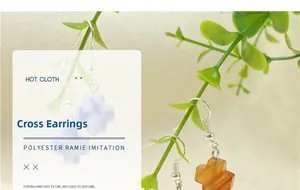 Detail view of cross earrings featuring blue and orange faux stone marble textures