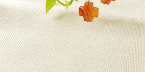 Detailed view of natural agate cross earring with orange-brown textured stone patterns