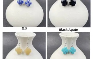 Cross earrings featuring natural blue spot stone and black agate with silver hooks