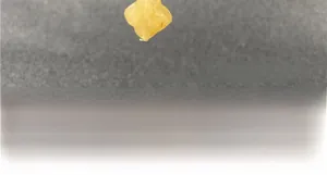Detailed view of yellow aventurine clover earring with artisanal hand-crafted texture