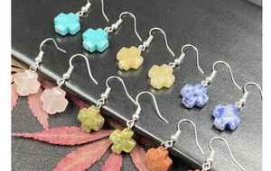 Detailed close-up of colorful natural stone cross earrings in assorted quartz and agate