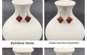 Macro detail of clover-shaped rainbow stone and gold sandstone earrings on a ceramic vase