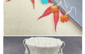 Detail of bohemian cross earrings featuring orange agate and turquoise stone textures