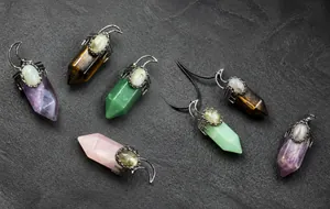 Macro shot of hexagonal crystal pendants with vintage crescent moon metal caps