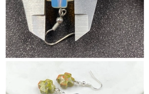 Detail view of crystal cross earrings with width measurement using a caliper tool