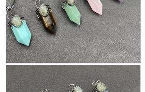 Macro detail of hexagonal crystal pendants with vintage silver floral engraving and moonstone