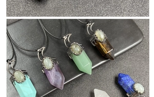 Macro shot of assorted hexagonal crystal cone pendants with vintage metal floral caps