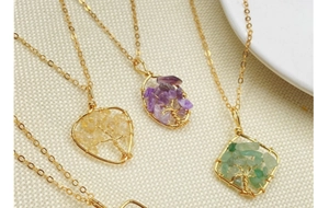 Detailed close-up of handmade tree of life necklaces with natural amethyst and aventurine