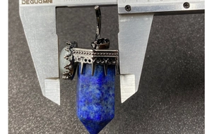 Lapis lazuli hexagonal pendant measuring 25mm width with crown setting and caliper tool