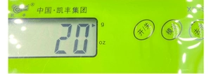 Macro shot of green digital kitchen scale showing LCD display and physical buttons