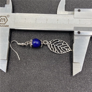Lapis lazuli and silver leaf earrings displayed with a caliper measuring 5.5cm length