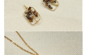 Detail of handmade gold wire-wrapped heart tree necklace with brown crystal stones