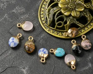 Detailed macro view of faceted semi-precious stone pendants with gold plated edges