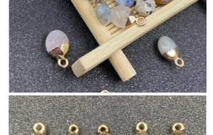 Close-up of assorted natural semi-precious stone pendants with gold plated edges for DIY jewelry