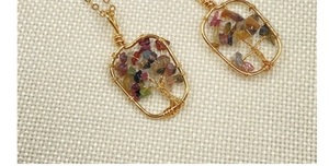 Detail of handmade gold wire-wrapped Tree of Life pendant with colorful crystal stones