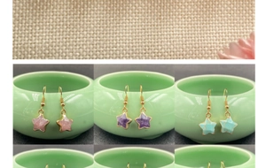 Detail of star-shaped crystal drop earrings with gold plated frames in multiple colors