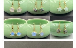 Detail of six colorful star-shaped gemstone earrings with gold-plated edges and hooks