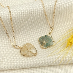 Handmade Tree of Life crystal necklaces in heart and square frames on a soft fabric