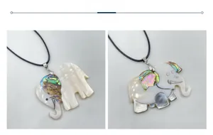 Detail of elephant pendants made of mother of pearl and abalone shell with black cords