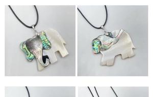 Macro detail of elephant shell pendant with abalone shell inlay and white mother of pearl