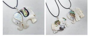 Detailed close-up of elephant shell pendants with mother of pearl and abalone inlay