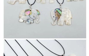 Detailed macro view of elephant pendants featuring white shell and colorful abalone shell inlays