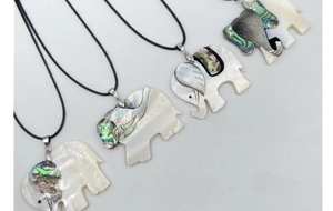 Detail of elephant pendants crafted from white mother of pearl and iridescent abalone shell