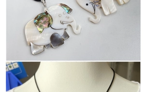 Detail of elephant pendant featuring white mother of pearl and rainbow abalone shell inlay