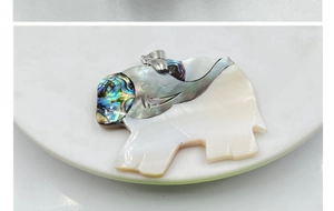 Detail of elephant pendant featuring white mother of pearl and iridescent abalone shell