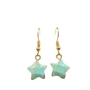Star-shaped light green turquoise earrings with gold-plated edges on a white background