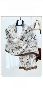 Detail of cotton linen scarf with vintage paisley print and contrast stitched edges