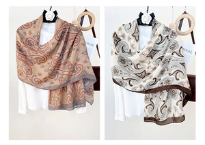 Detail of lightweight cotton linen shawls featuring vintage paisley patterns and contrast borders