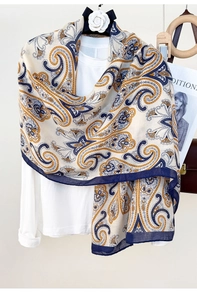 Detail of paisley print lightweight scarf with navy blue borders and elegant drape