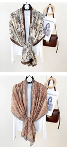 Detailed view of silk-like paisley shawls paired with white shirt and brown leather bag