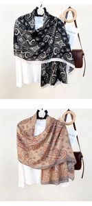 Detail of vintage paisley print scarves in black and khaki with a lightweight drape