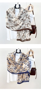 Close-up of lightweight paisley cotton linen scarves in brown and navy blue patterns